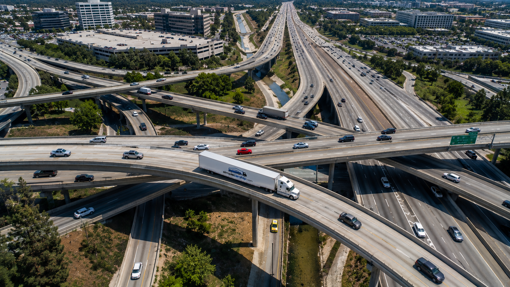 Aerial view of an open auto-transport carrier on the interstate shipping a car from New York to Colorado